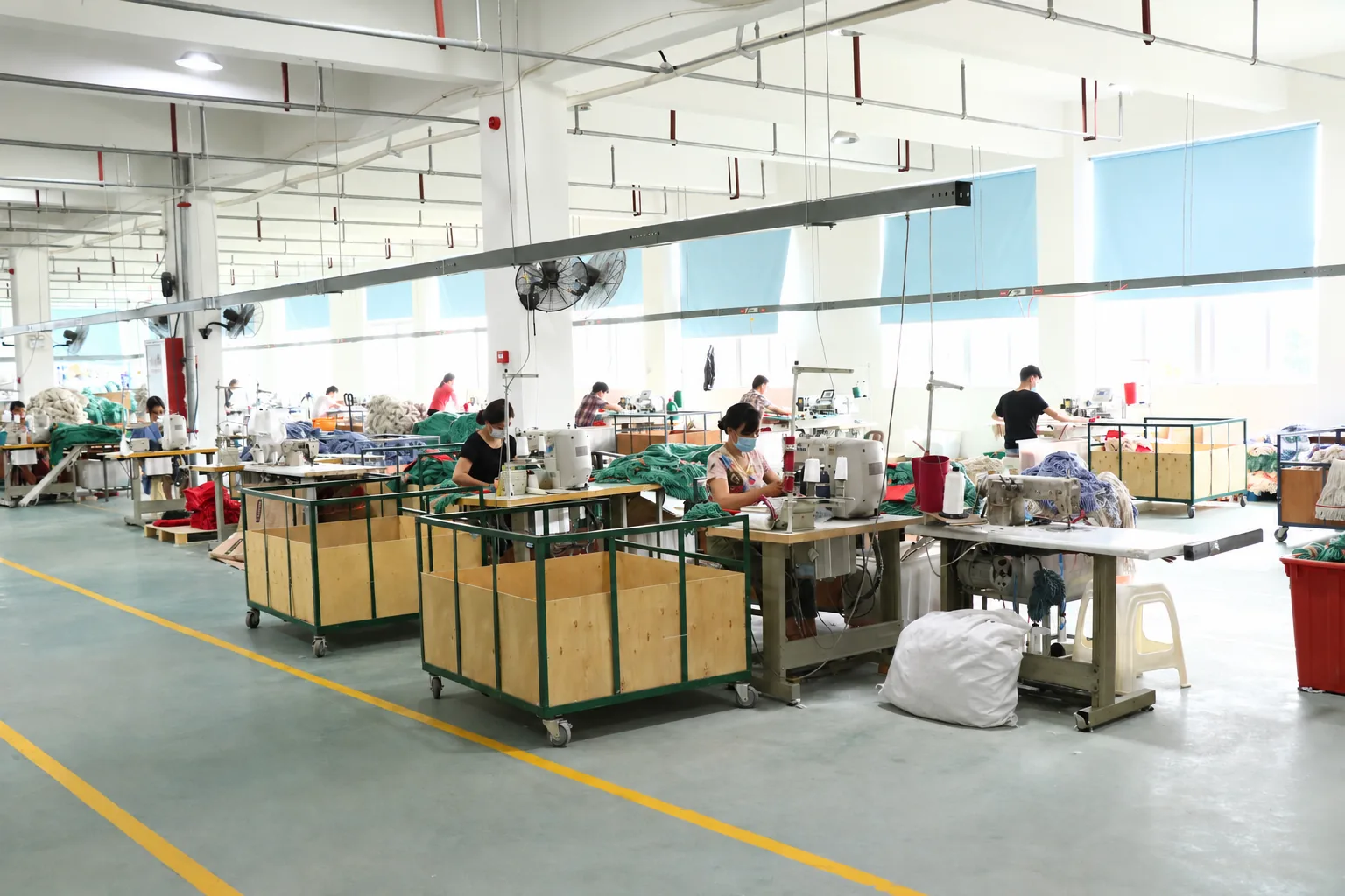 Workers sewing textiles on the Chaison factory floor